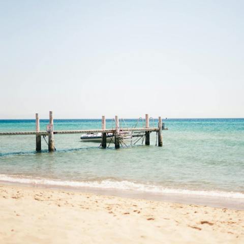 Spend a day on the sand at Platja de la Gola del Ter, a fifteen-minute drive away