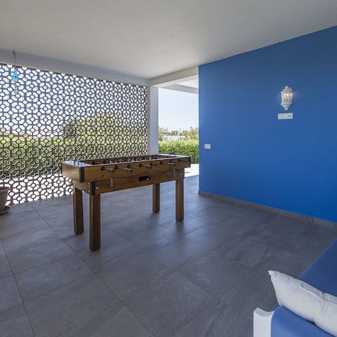 Battle it out with a game of table football table under the veranda