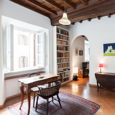 Get some work done in the study brimming with books – the window overlooks Largo dei Librari 