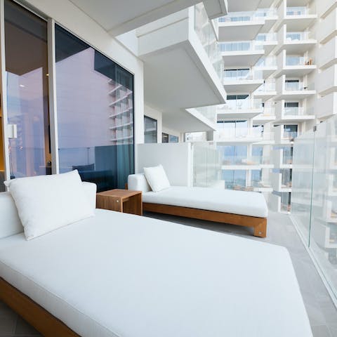 Lounge on the balcony day beds while sipping on your morning Gahwa