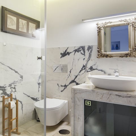 Freshen up in striking marble bathrooms