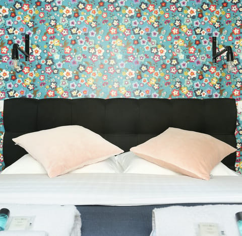 Slumber in style with the flower-power-themed wallpaper in the bedroom