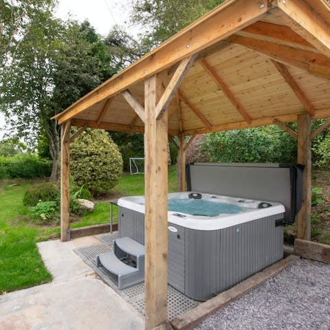 Soak in the hot tub and admire the countryside views