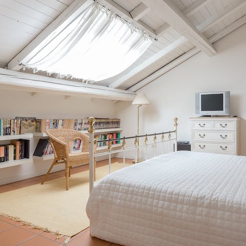Curl up with a good book beneath the second bedroom's roof window