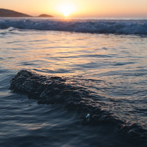 Make the short drive to nearby Camps Bay to watch the sun set
