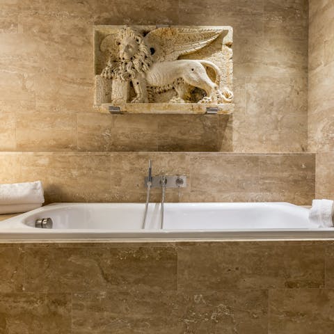 Sink into the marble bath after a long day of sightseeing
