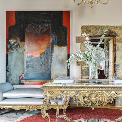 Admire the original artworks and antique furniture that fills the home