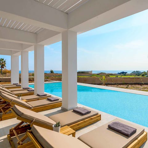 Laze on luxe loungers beside the pool and top up your tan