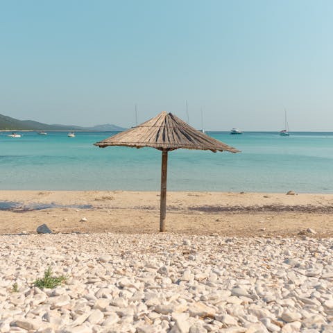 Lounge about on the sands of Arenal de Sa Ràpita, a six-minute drive away