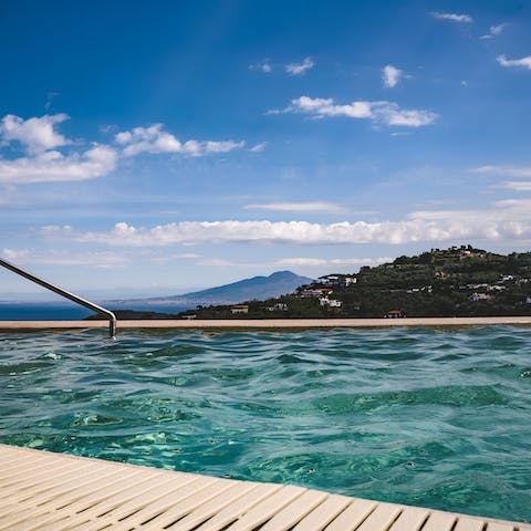 Enjoy glimpses of the Tyrrhenian Sea as you float in the pool