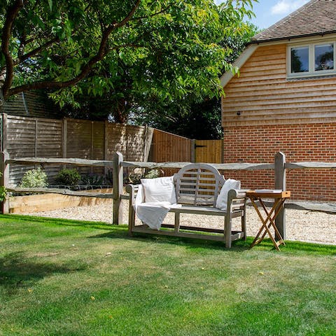 Enjoy a glass of fizz from the local vineyard on the garden bench