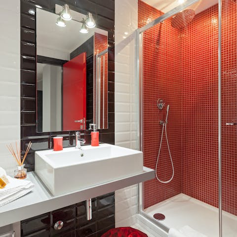 Start mornings with a relaxing soak under the red bathroom's rainfall shower