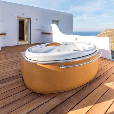 Soak in the hot tub on the balcony overlooking the Aegean