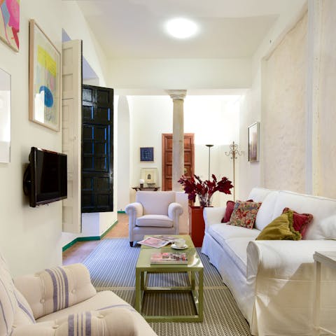 Relax in the inviting living room with a glass of Spanish wine after a day of exploring the city