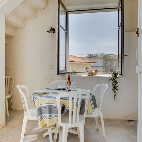 Organise delicious meals at the dining table, looking out onto the lovely architecture  
