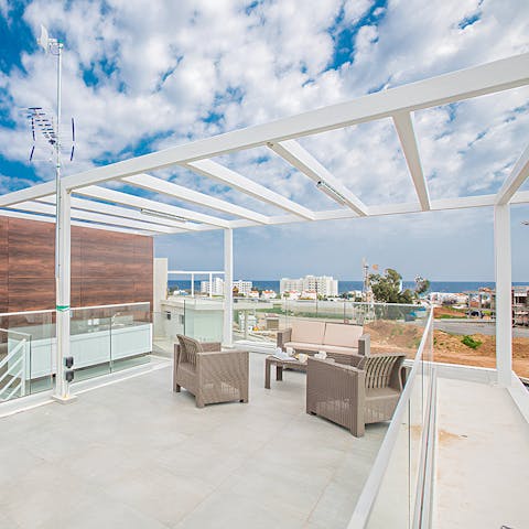 Watch the sunset over the sea from the roof terrace