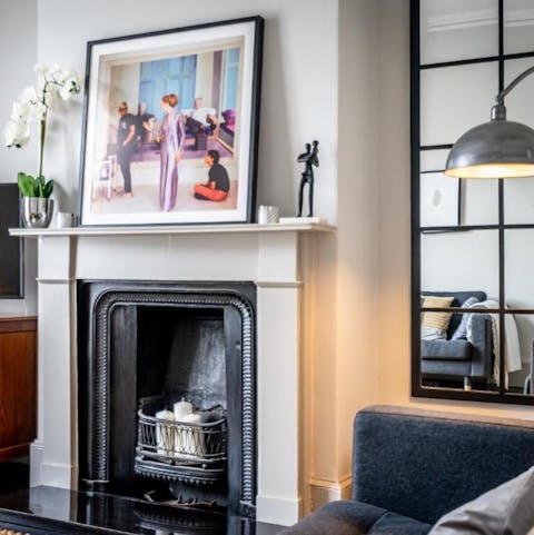 Curl up by the fire in the chic living room that oozes understated elegance