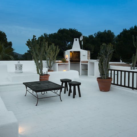 Fire up the built-in barbecue on the striking white rooftop terrace