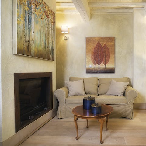 Cosy up by the fireplace in your calming lounge on chilly winter evenings