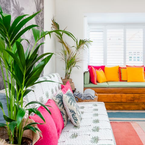 Relax amidst the palms in the vibrant  living room