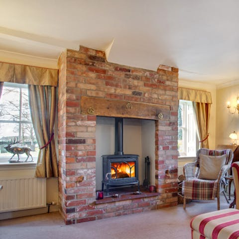 Cosy up by the warmth of the wood burning stove