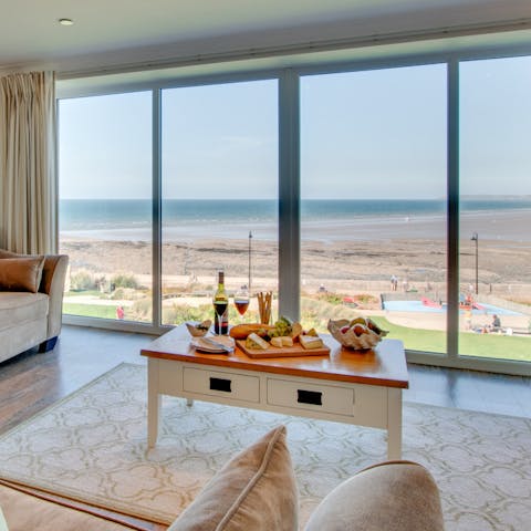 Enjoy happy hour the right way with some cheese, wine and charcuterie overlooking the sea from the living room 