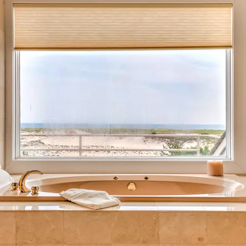 Soak in the deep tub with views of the ocean as your backdrop