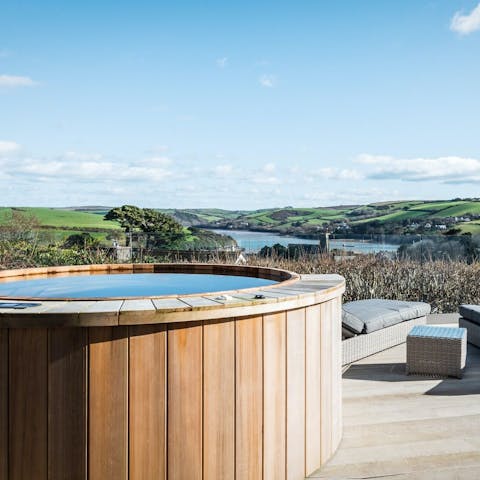 Enjoy a dip in the hot tub, admiring the coastal views