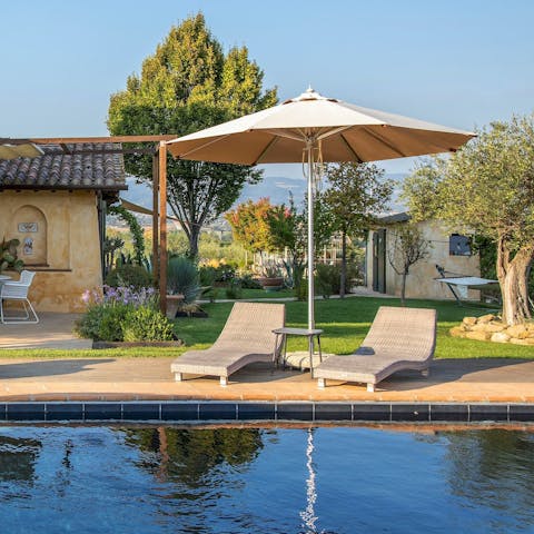 Relax by the private outdoor pool and soak up the sun with a drink in hand