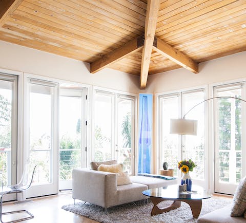 Exposed wood ceiling in the sunny living room