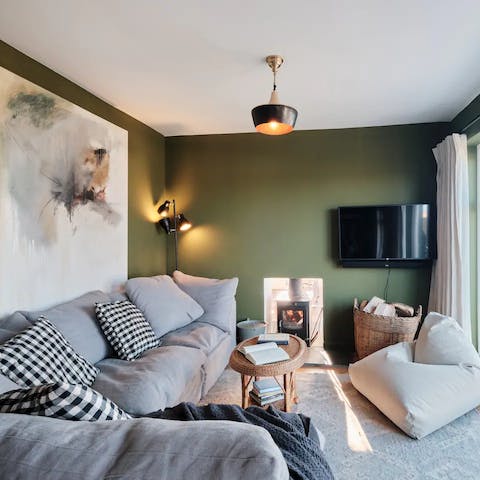 Spend cooler days cosied up on the corner sofa by the fire 