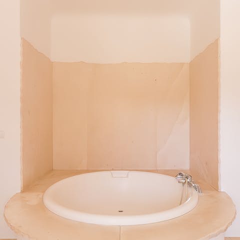 Treat yourself to a nighttime soak in the large bath tub