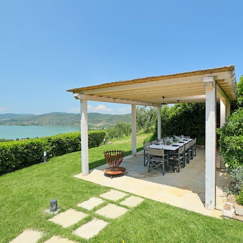 Gather around the dining table under the covered veranda and light the barbecue 