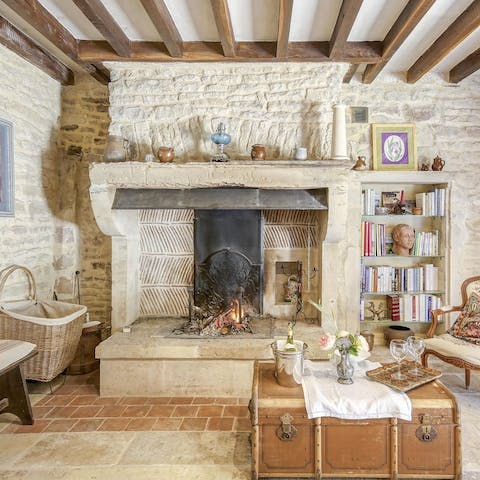 Snuggle up by the living room's fire with a glass of French wine and one of the books on the shelves