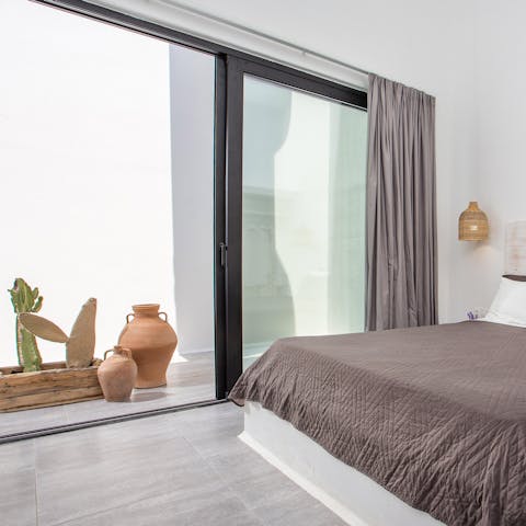 Open the bedroom patio doors to your private terrace with its terracotta pots and cacti
