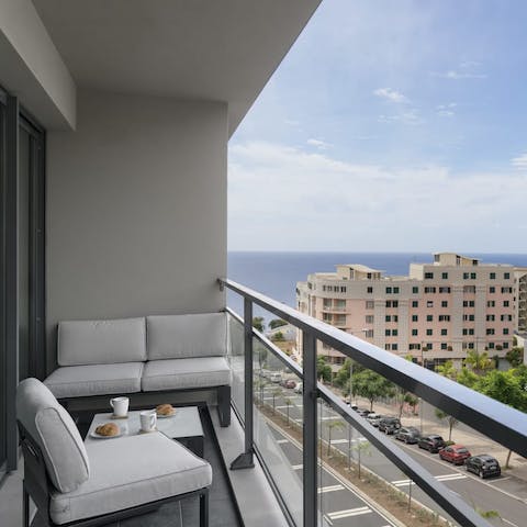 Relax on your own private balcony with stunning views of the city and ocean horizon