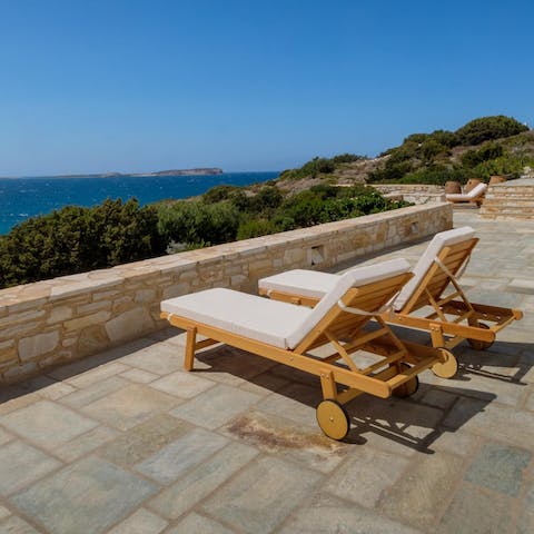 Stretch out on a sun lounger and admire the beautiful sea view