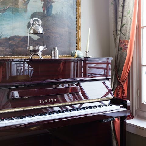 Play a few tunes on the piano in the sitting room 