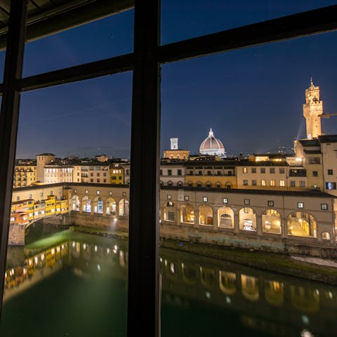 See the city lit up around the River Arno, right from your window
