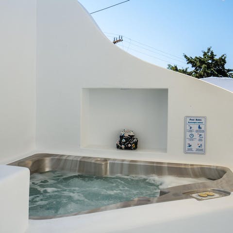 Unwind in the hot tub with a glass of something chilled in hand