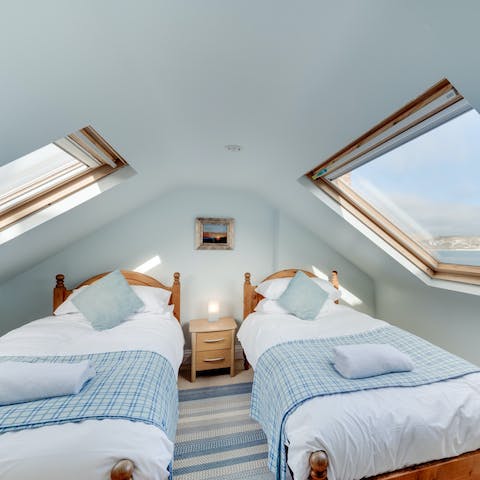 Put the kids upstairs in the skylit eaves, where they'll wake up to sea views