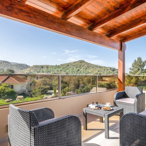 Gaze out at wonderful views of the Grecian hills and lush green trees surrounding you