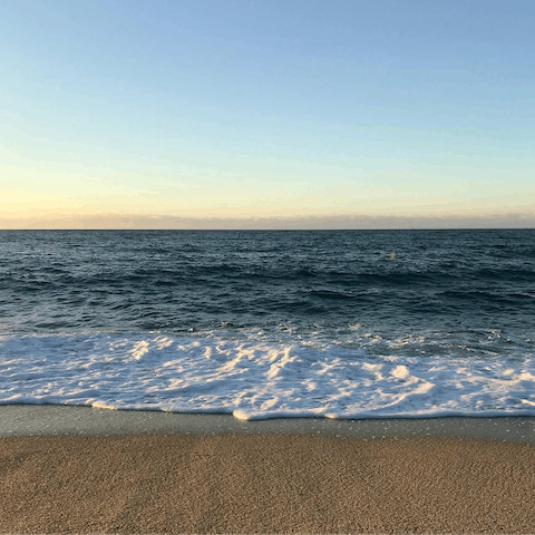 Wander the sandy beach shores – a short seven-minute walk from your door