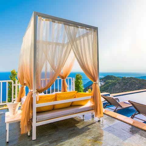 Relax on a daybed as you soak up sea views by the private plunge pool