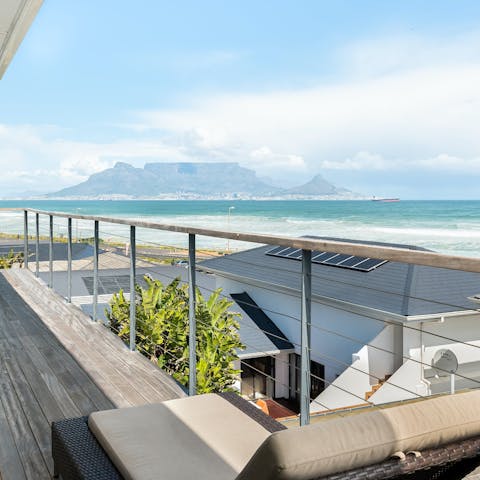 Admire the views over the beach and Robben Island from the balcony