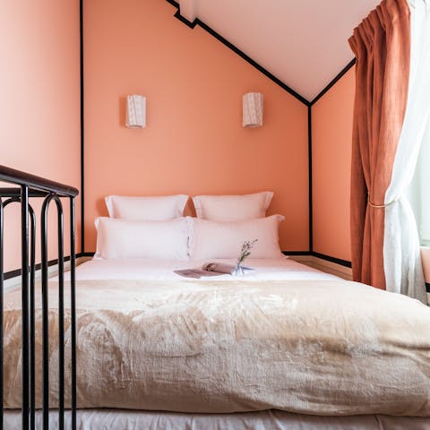 Get a restful night's sleep in the peach-toned mezzanine bedroom