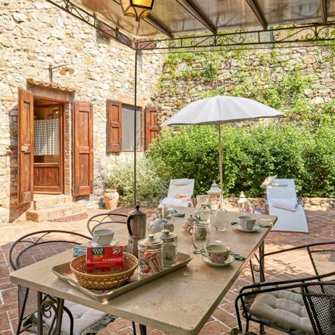 Enjoy meals alfresco around the table, shaded from the sun beneath the pergola