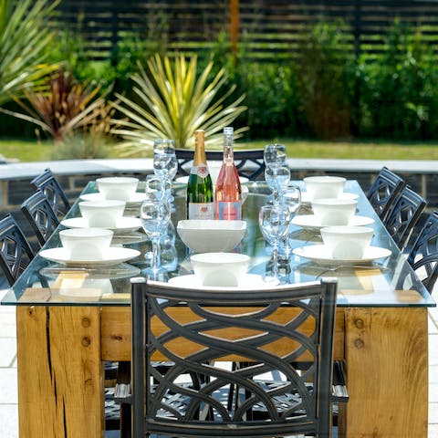 Fire up the barbecue and dine outside as the sun goes down over the garden