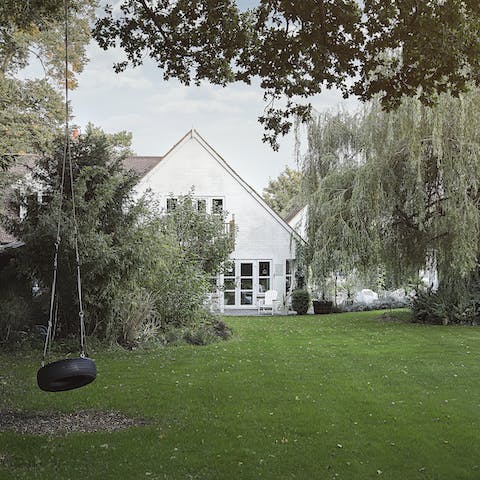 Swing on the tire by the weeping willow from your large and private garden