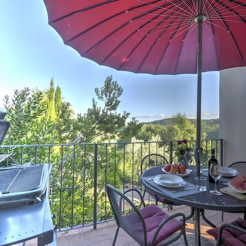 Enjoy a glass of wine as you prepare for a barbecue on your private terrace